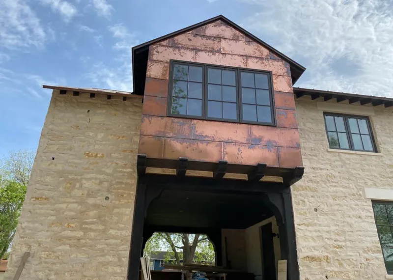 Copper metal panel facade on a stone building for Skylight Installation in Hermiston